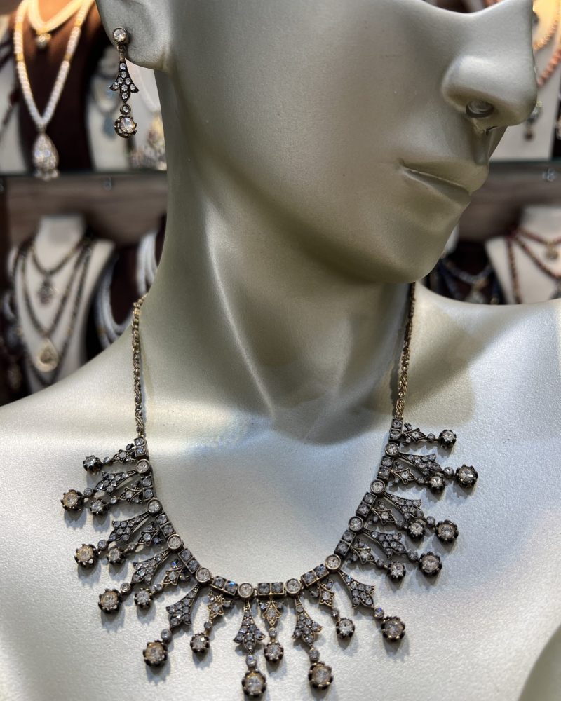 Parure Lalla Soraya 2 pièces dorée comprenant un collier draperie et des boucles d'oreilles pendantes en bronze traité à l'or et cristaux clairs